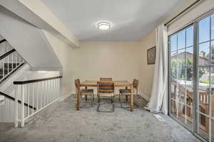 Carpeted dining room featuring baseboards