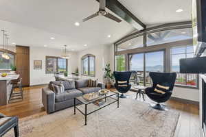 Living area with hardwood / wood-style floors, recessed lighting, a ceiling fan, and a chandelier