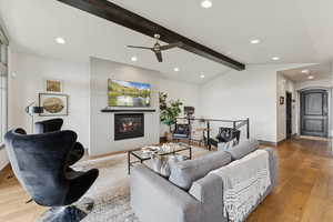 Living room with wood-type flooring, a fireplace, recessed lighting, and ceiling fan