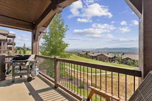 Balcony with grilling area, a mountain view, and a residential view
