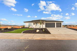 Prairie-style house featuring stucco siding, concrete driveway, and a garage