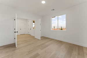 Unfurnished room with light wood-type flooring and recessed lighting