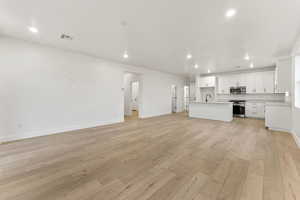 Unfurnished living room featuring recessed lighting and light wood-type flooring