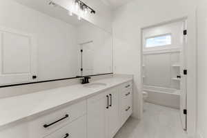 Full bath with vanity, shower / washtub combination, and light tile patterned flooring