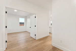 Empty room with light wood-type flooring and recessed lighting