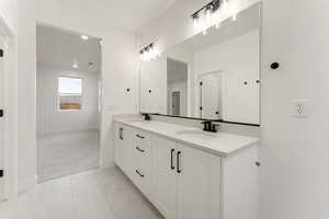 Full bath with double vanity, light tile patterned floors, light carpet, and recessed lighting