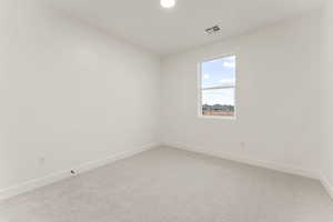 Empty room featuring light colored carpet and recessed lighting