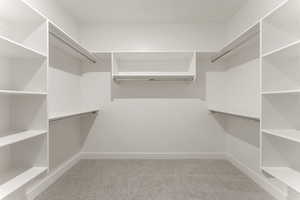 Walk in closet with light carpet