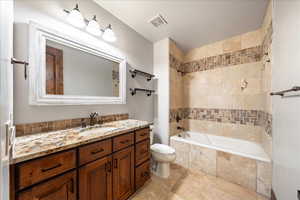 Full bath featuring vanity and tiled shower / bath combo