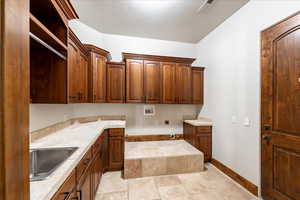 Washroom with cabinet space, washer hookup, and hookup for an electric dryer