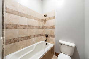 Bathroom featuring shower / tub combination and toilet