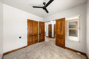Unfurnished bedroom featuring light colored carpet and ceiling fan