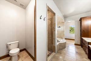 Bathroom with vanity, a bath, tile patterned floors, and a tile shower