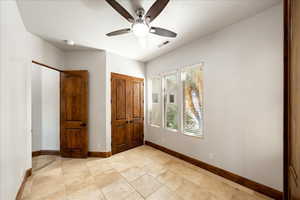 Unfurnished bedroom featuring baseboards and a ceiling fan
