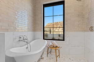 Full bathroom with a freestanding bath, a mountain view, and tiled shower