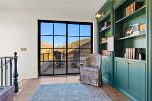 Sitting room with a mountain view and wood finished floors