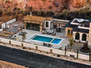 View of pool with an outdoor hangout area, a patio, an outdoor bar, an outbuilding, and a storage structure