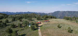 Aerial view of property's location with a mountainous background and rural landscape