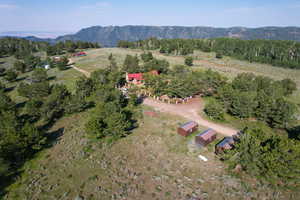 Aerial view of property and surrounding area with rural landscape and a mountain backdrop