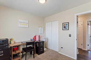 Home office featuring baseboards and carpet