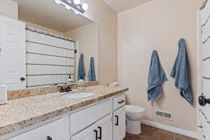 Bathroom with vanity, tile patterned flooring, and a shower with curtain