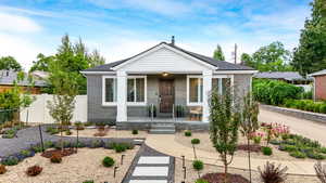Front of brick Bungalow home with front lounge area and fully xeriscaped front yard, future oasis in the making.