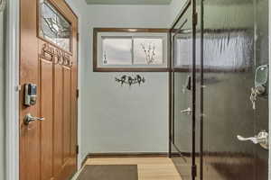 Entryway featuring wood finished floors and baseboards