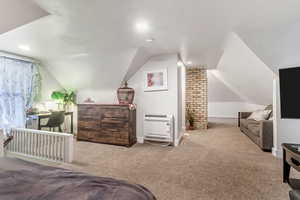 Bedroom featuring carpet floors, heating unit, vaulted ceiling, and recessed lighting