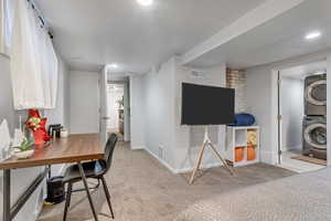 Office area with stacked washer / drying machine, carpet floors, and recessed lighting