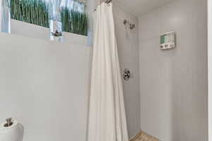 Full bathroom with tiled shower