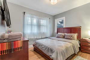 Bedroom featuring light wood-style floors and baseboards