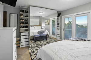 Carpeted bedroom with access to outside