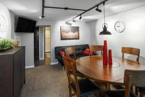 Dining area featuring track lighting and carpet