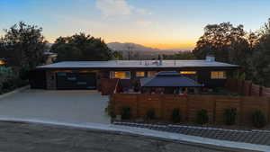 View of front of property with a mountain view, a chimney, a gazebo, driveway, and an attached garage
