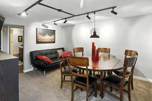Dining room featuring rail lighting and carpet floors
