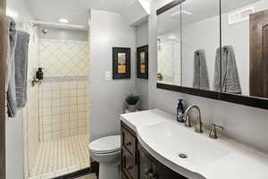 Bathroom with vanity and tiled shower