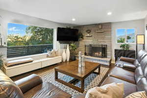 Living room featuring wood finished floors, a fireplace, and recessed lighting