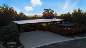 View of front of property with an attached garage and concrete driveway