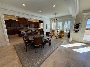 Dining room with crown molding, a chandelier, and recessed lighting