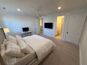 Bedroom featuring ornamental molding, light carpet, recessed lighting, ensuite bath, and ceiling fan