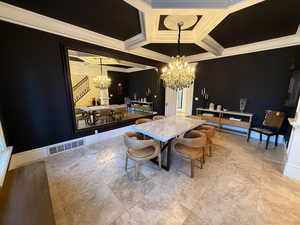Dining room featuring a chandelier, crown molding, coffered ceiling, and beam ceiling