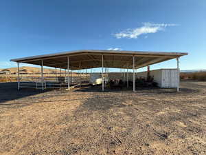 View of parking with a detached carport