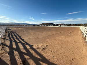 View of yard featuring an outdoor riding arena and a mountain view