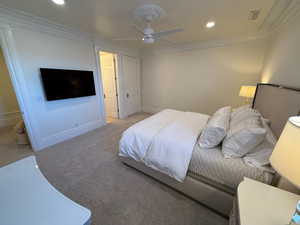 Carpeted bedroom with ornamental molding, recessed lighting, and a ceiling fan