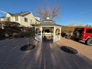View of patio / terrace with curved driveway and a gazebo