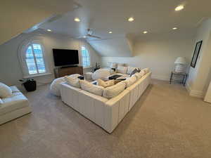 Living area with light colored carpet, crown molding, recessed lighting, lofted ceiling, and a ceiling fan