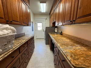 Laundry area featuring separate washer and dryer and cabinet space