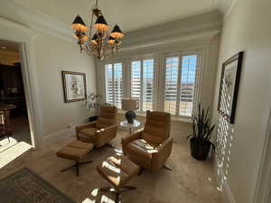 Sitting room featuring a chandelier and ornamental molding