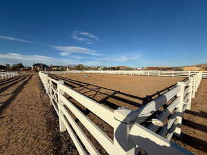 View of yard with an enclosed riding area and a view of countryside