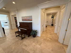 Hall with crown molding and recessed lighting